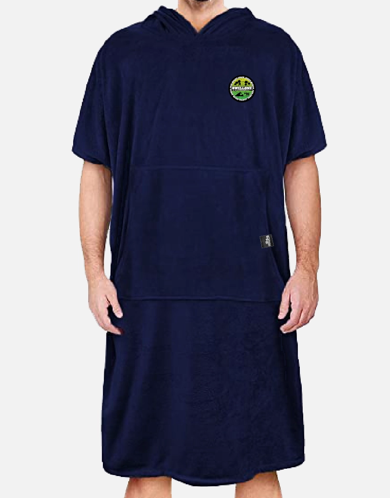 Person standing, wearing a navy blue Swellone surf poncho.