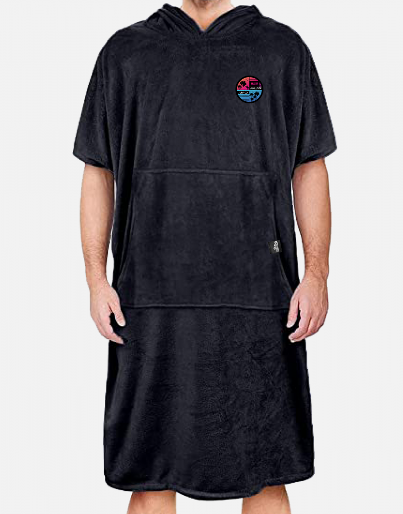 Person standing, wearing a black Swellone surf poncho.