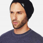 Man wearing a black eco beanie with Swellone logo.