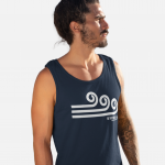 Man standing and wearing a navy blue Swellone tank top.