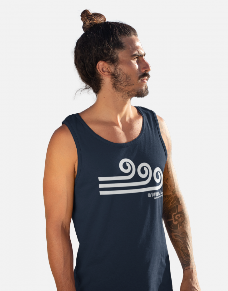 Man standing and wearing a navy blue Swellone tank top.