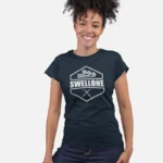 Woman standing and wearing a navy Swellone tshirt.