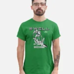 Man wearing a kelly green Swellone tshirt with Skelton surf logo.